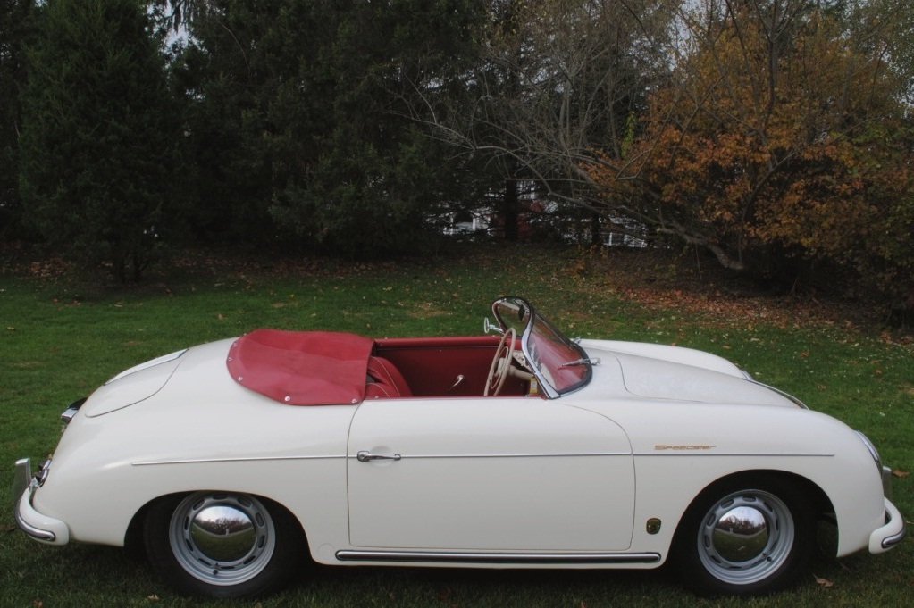 1957 Porsche 356A Speedster in white with red seats, full engine rebuild, new chrome, and factory-matching documentation.