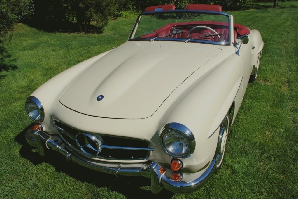 Factory-matching 1959 Mercedes-Benz 190SL convertible, with fresh chrome and rich red upholstery craftsmanship.